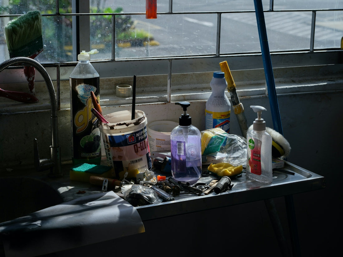 Various cleaning supplies and tools on a shelf