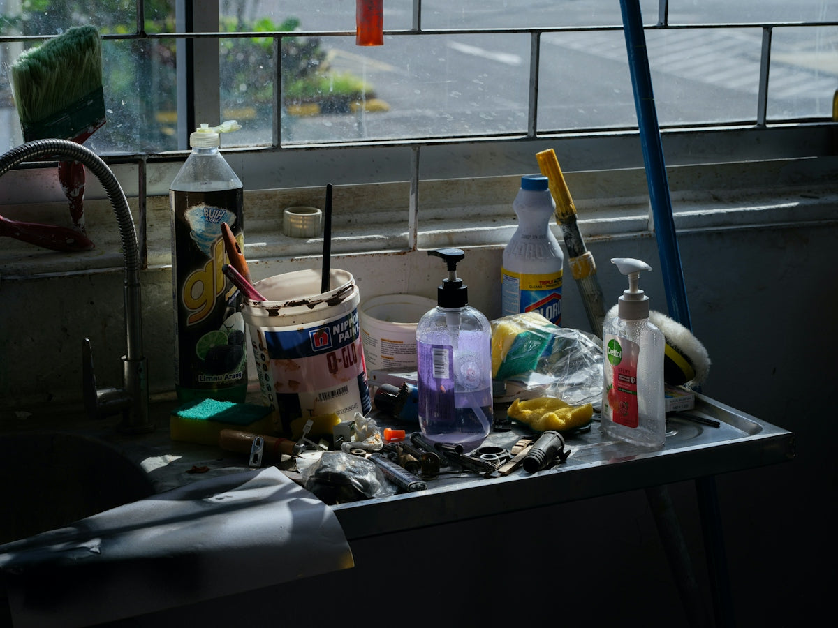 Various cleaning supplies and tools on a shelf